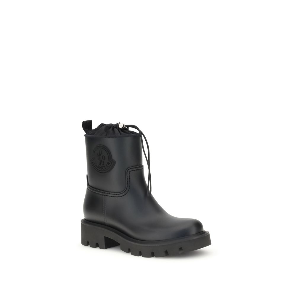 Side angle of Moncler Kickstream rubber boots featuring rugged sole, black finish, and signature logo, ideal for women's fall footwear.