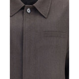 Close-up of Brioni Herringbone Jacket highlighting fine brown herringbone weave, button detail, and chest pocket stitching.