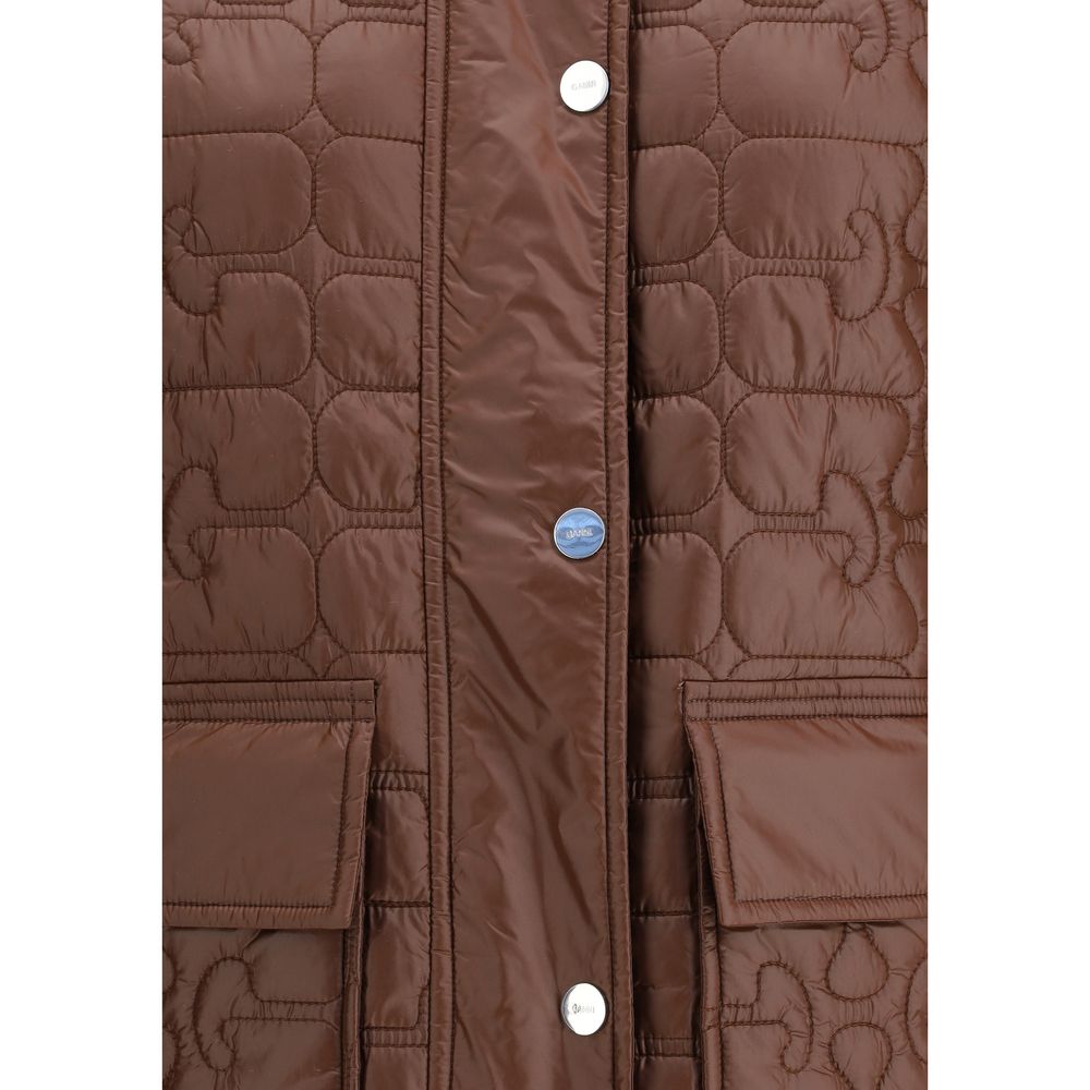 Close-up of Ganni Shiny Quilt Midi Jacket highlighting shiny quilted fabric, branded snap buttons, and front flap pockets. Premium detail for outerwear.
