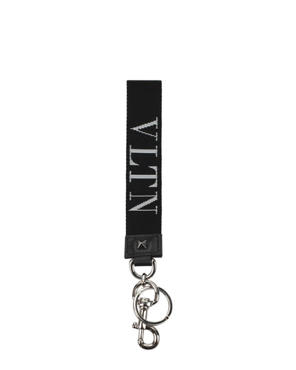 Valentino Garavani black fabric keychain with white VLTN logo, silver-tone hardware, and keyring clip. Stylish men's accessory for bags or keys.