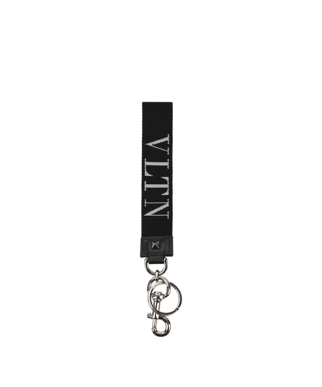 Valentino Garavani black fabric keychain with white VLTN logo, silver-tone hardware, and keyring clip. Stylish men's accessory for bags or keys.