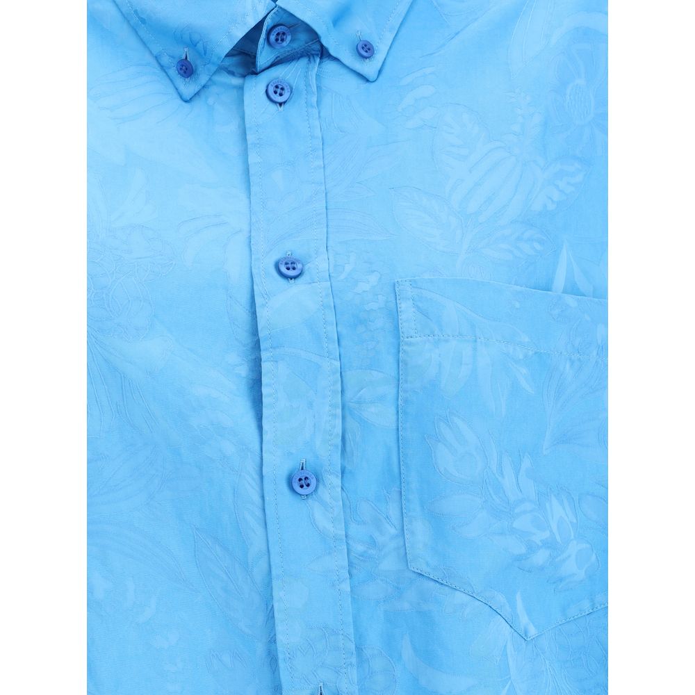Close-up of Balenciaga Cocoon Shirt highlighting the textured floral pattern, chest pocket, and button details in premium blue fabric.