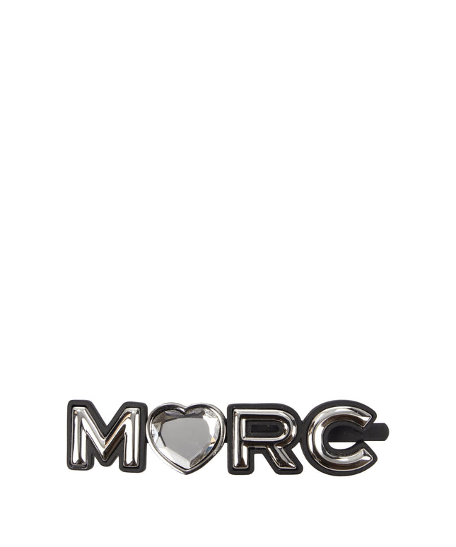 Marc Jacobs gray brass hair clip spelling 'MARC' with a heart-shaped gem in place of the letter 'A', stylish accessory for women.