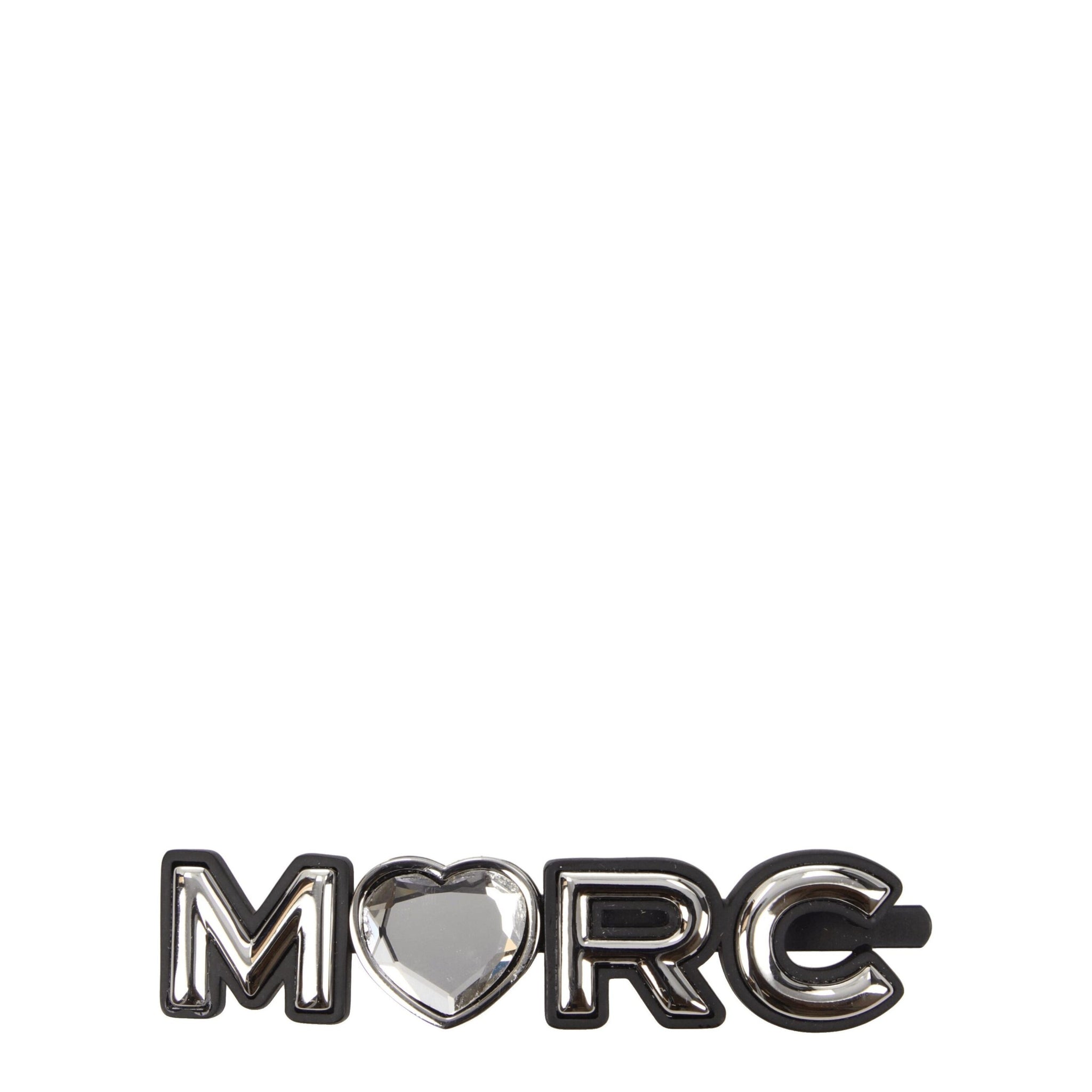 Marc Jacobs gray brass hair clip spelling 'MARC' with a heart-shaped gem in place of the letter 'A', stylish accessory for women.
