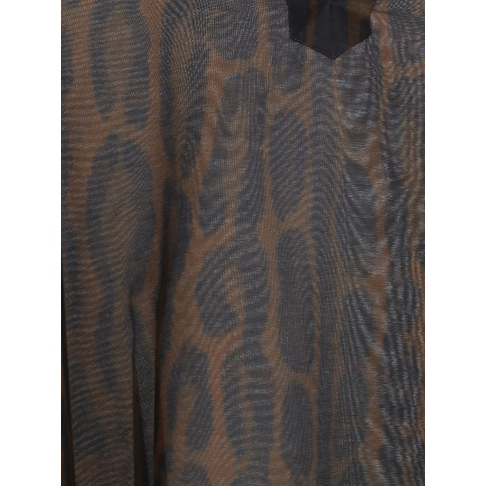 Close-up of Tom Ford Kaftan Dress fabric highlighting the sheer texture and brown-black animal print design for a stylish statement.