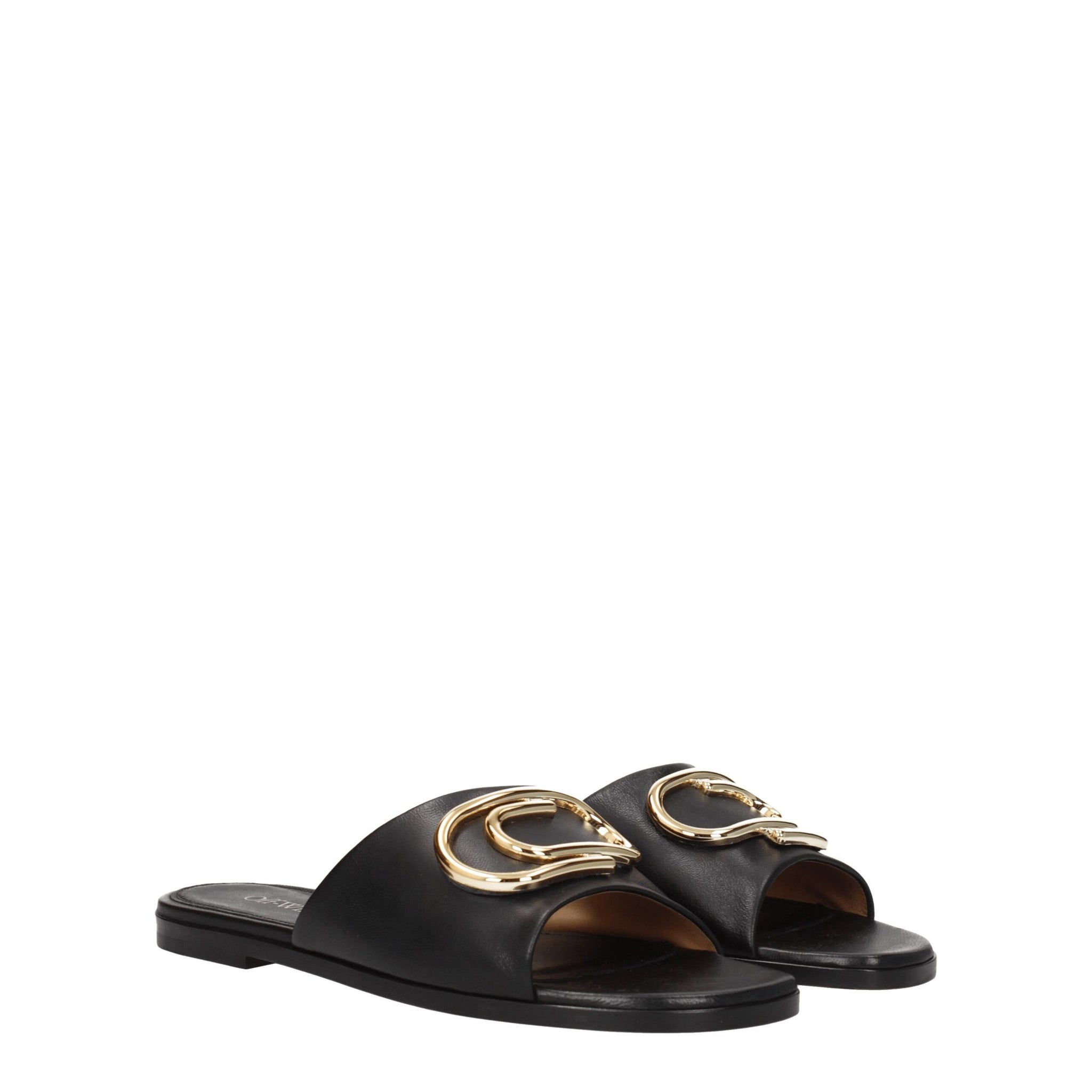 Pair of Off-White Black Leather Slippers Sandals with signature gold embellishments, ideal for women’s designer summer footwear collections.