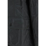 Close-up of Barbour Breadnell waxed Jacket pocket detailing with embossed Barbour logo and snap-button closure in green waxed cotton.