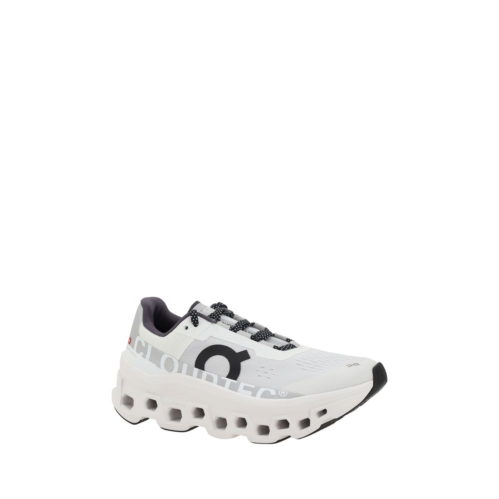Side angle of ON Cloudmonster Sneakers showcasing cushioned CloudTec sole and breathable mesh upper, ideal for women’s performance running.
