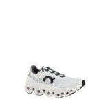 Side angle of ON Cloudmonster Sneakers showcasing cushioned CloudTec sole and breathable mesh upper, ideal for women’s performance running.