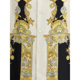 Close-up of Versace Silk Shirt front showcasing intricate gold baroque detailing with seashells and columns on luxurious silk fabric.