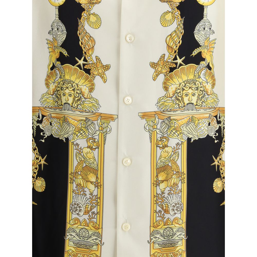 Close-up of Versace Silk Shirt front showcasing intricate gold baroque detailing with seashells and columns on luxurious silk fabric.