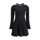 Valentino Knit Dress with volants in black featuring long sleeves, a flared skirt, and ruffled neckline and cuffs. Ideal for casual chic wear.