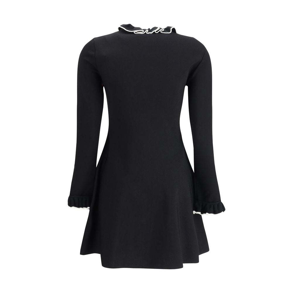 Back view of Valentino Knit Dress with volants in black, showcasing ruffled collar and cuffs with a flattering A-line silhouette. Elegant casual style.