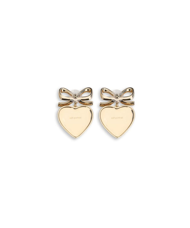 Back view of Self-Portrait Heart shaped bow Earrings in polished gold-tone finish with engraved branding, elegant jewellery for women’s fashion.