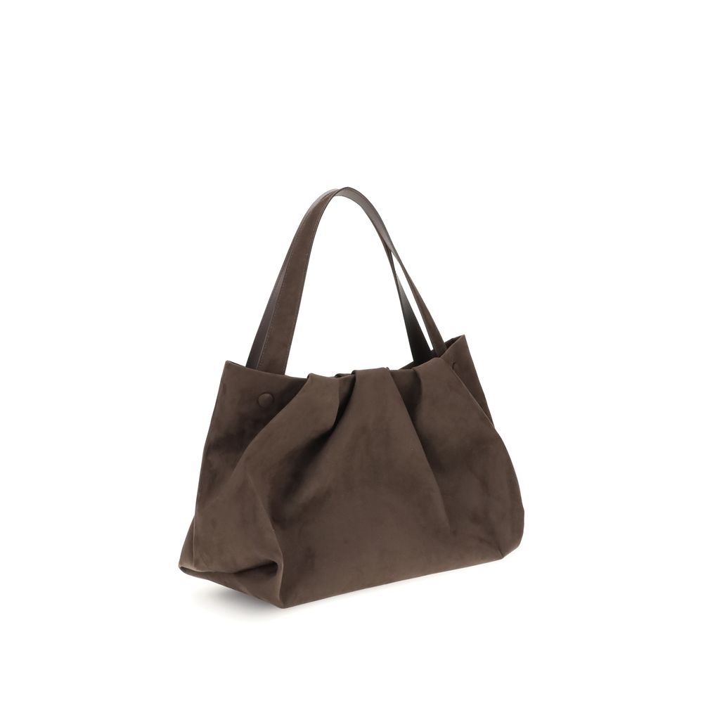Side view of THEMOIRè Athena Shoulder Bag showcasing its structured silhouette and rich brown suede texture, perfect for stylish shoulder wear.