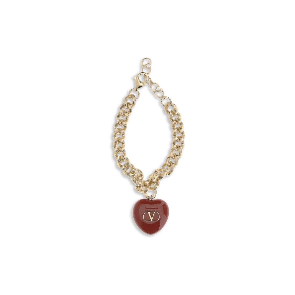 Valentino Garavani Coeur Royal chain bracelet featuring a gold-tone chain and red heart charm with signature V logo, ideal for luxury women's accessories.