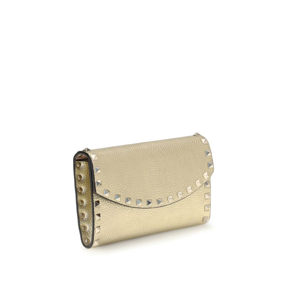 Angled side view of Valentino Garavani Rockstud chain Wallet showcasing gold-tone leather and iconic stud embellishments, perfect for luxury fashion.