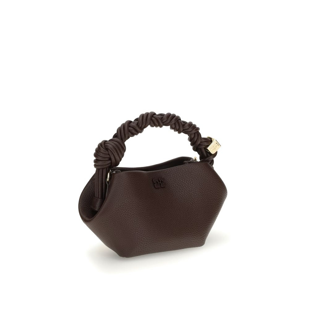 Side view of Ganni Grainy Bou mini Handbag showcasing its sculpted shape and knotted leather handle, perfect for stylish everyday use.