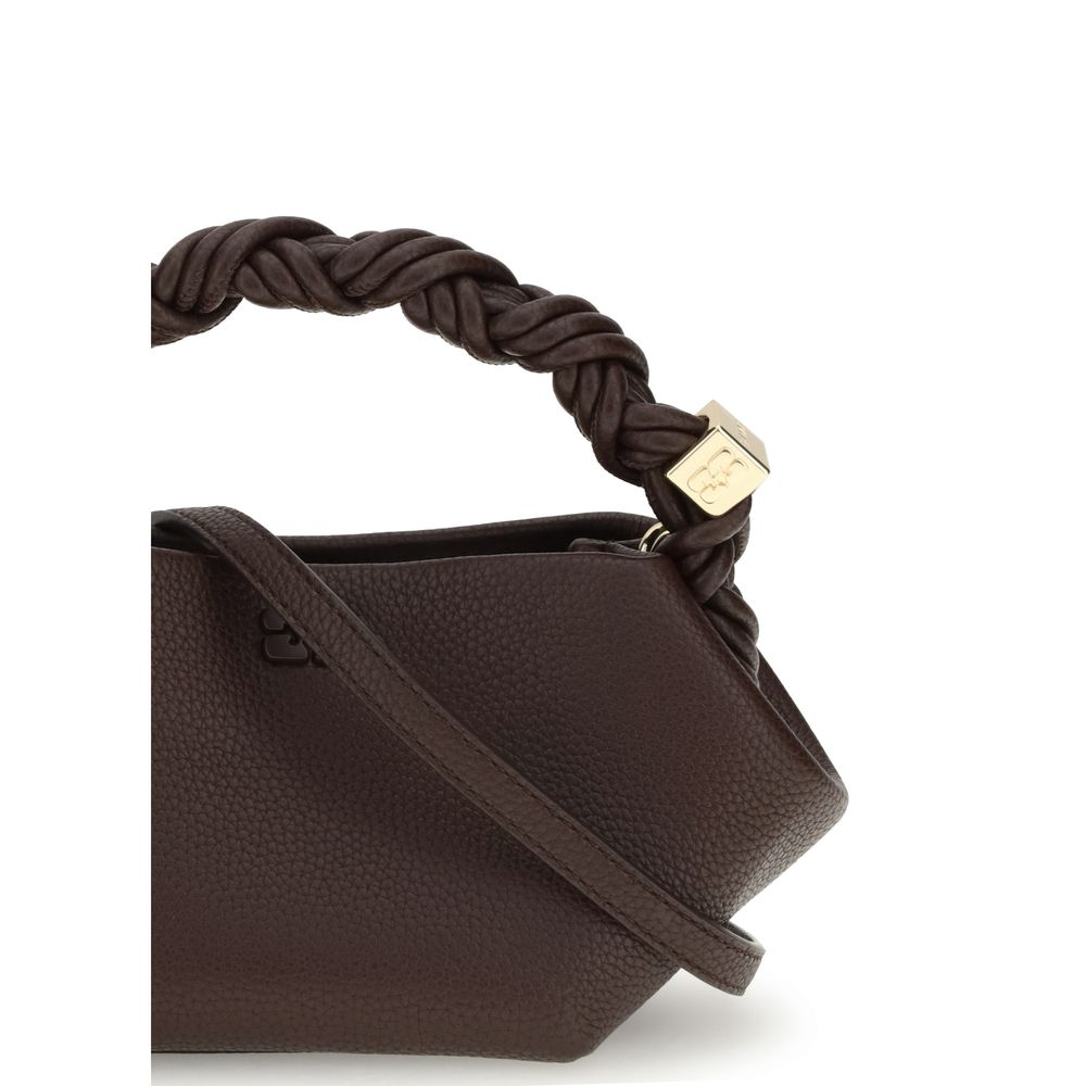 Close-up of Ganni Grainy Bou mini Handbag handle detail with twisted leather design and engraved gold-tone cube hardware.