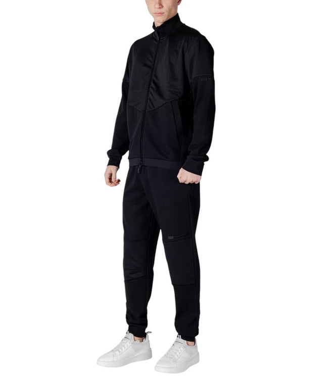 Side angle of EA7 Emporio Armani Black Cotton Sweatsuit highlighting the sleek fit and textured fabric details on the jacket.