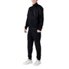 Side angle of EA7 Emporio Armani Black Cotton Sweatsuit highlighting the sleek fit and textured fabric details on the jacket.