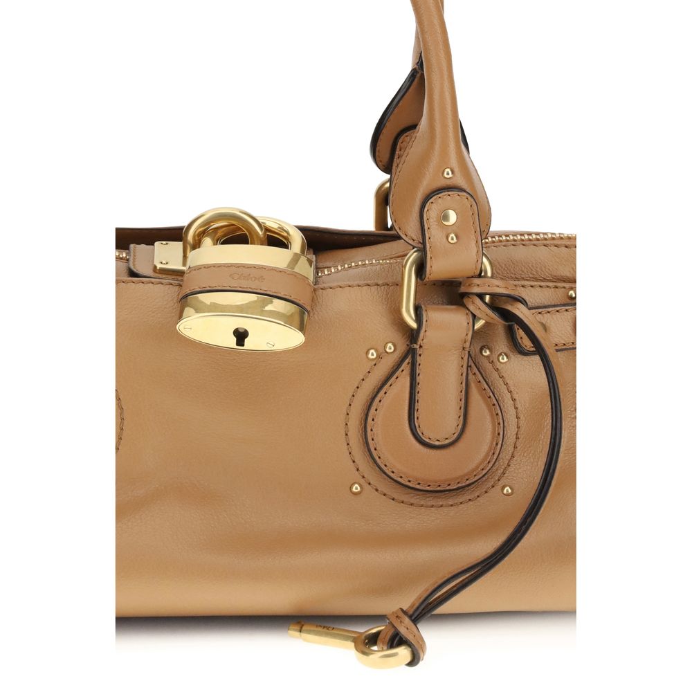 Close-up of Chloé Paddington Bag's iconic gold padlock and leather detailing, emphasizing luxury design and brand signature.