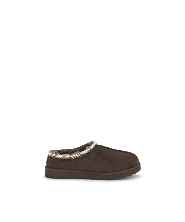 UGG Tasman II Mules in brown suede with plush lining, shown in side profile. Men's EU43/US10 flats ideal for casual wear.