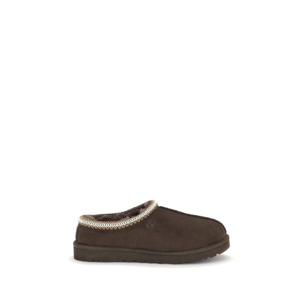 UGG Tasman II Mules in brown suede with plush lining, shown in side profile. Men's EU43/US10 flats ideal for casual wear.