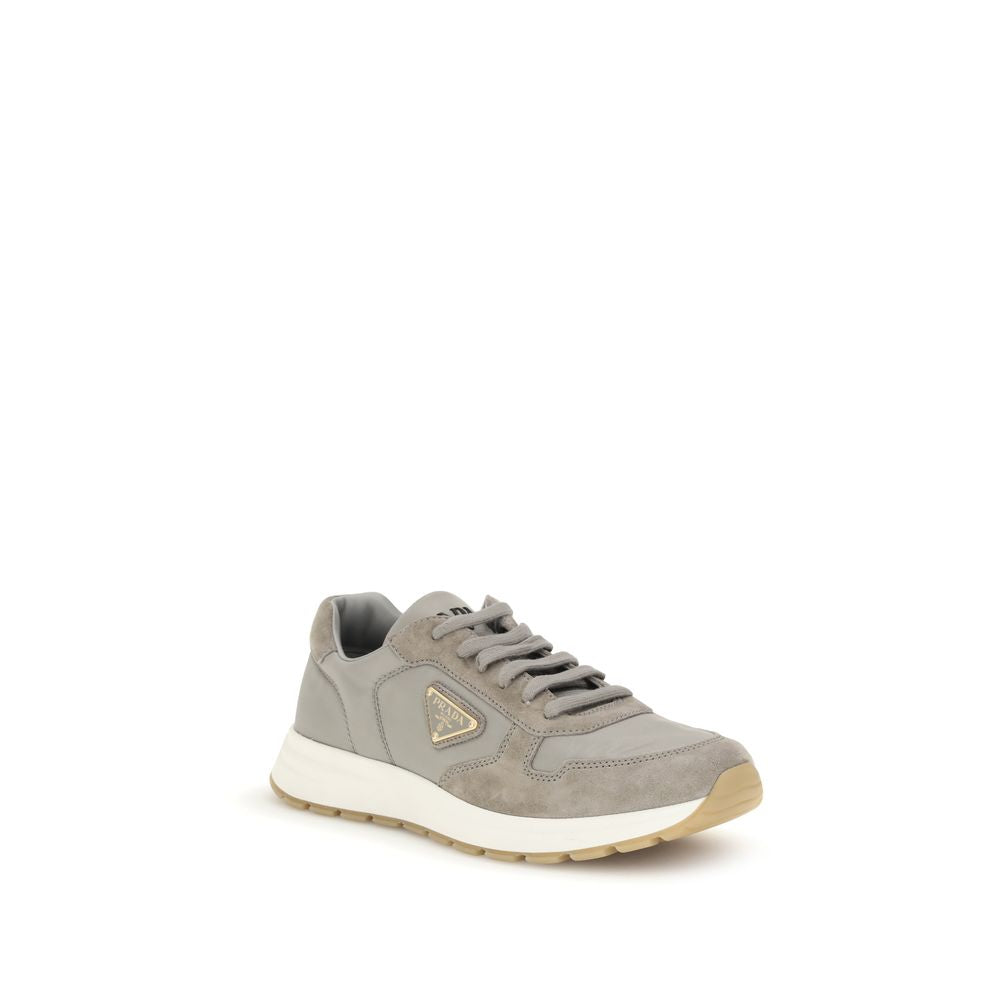 Gray Prada Prax 01 re-nylon sneakers featuring side logo triangle, lace-up front, and cushioned sole for athletic and casual wear.