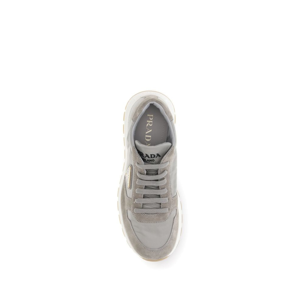 Top view of Prada Prax 01 re-nylon sneakers in gray with tonal laces, logo insole, and layered panel construction for premium comfort.