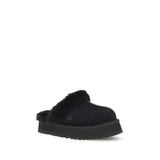 UGG Disquette Slides black women’s flats with elevated sole and cozy fur lining, angled front view ideal for casual comfort.