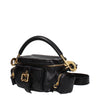 Side view of Chloé black leather handbag featuring dual side zip pockets, structured silhouette, and adjustable strap for versatile wear.