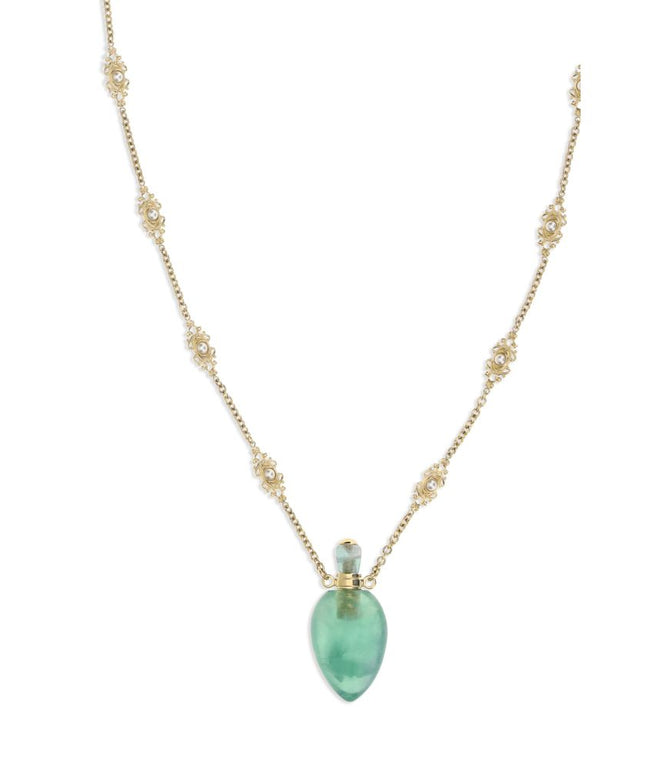 Close-up of Chloé Elixir Pendant Necklace showcasing ornate gold chain links and a translucent green pendant, ideal for luxury fashion styling.
