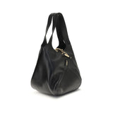 Side view of Chloé Small Balloon Shoulder Bag showcasing its soft black leather texture and elegant curved silhouette.