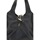 Close-up of Chloé Small Balloon Shoulder Bag featuring gold-tone chain detail and embossed Chloé logo on black leather.