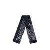 Destin Bandana Scarf shown folded lengthwise, highlighting its navy blue fabric and intricate white paisley pattern. Ideal for versatile styling.