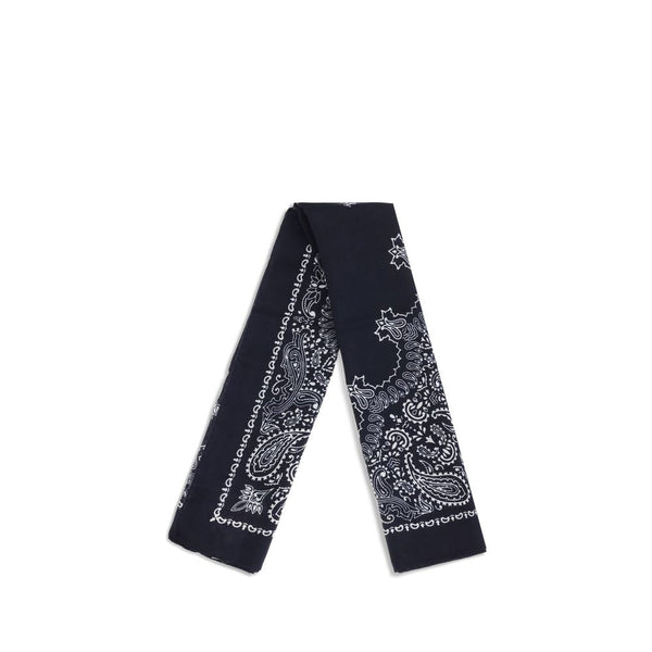 Destin Bandana Scarf shown folded lengthwise, highlighting its navy blue fabric and intricate white paisley pattern. Ideal for versatile styling.