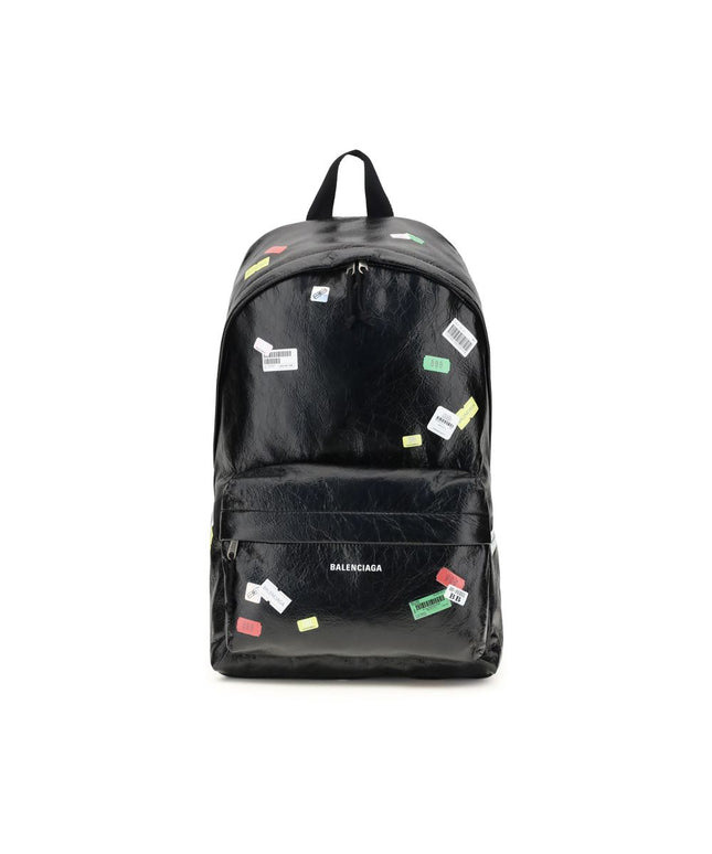 Balenciaga Explorer Backpack with printed stickers in black leather, featuring a front zip pocket and top handle for men’s fashion and travel.