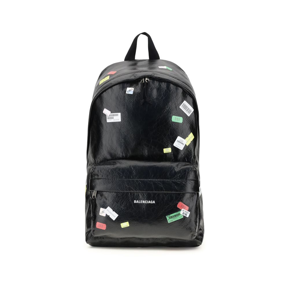 Balenciaga Explorer Backpack with printed stickers in black leather, featuring a front zip pocket and top handle for men’s fashion and travel.