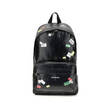 Balenciaga Explorer Backpack with printed stickers in black leather, featuring a front zip pocket and top handle for men’s fashion and travel.