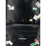 Close-up of Balenciaga Explorer Backpack showcasing printed sticker graphics and embossed logo, highlighting its designer streetwear appeal.